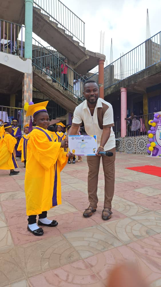 Graduating pupil shaking hands while collecting a certificate