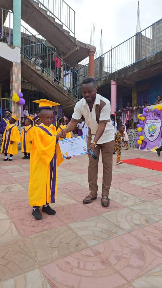 A graduate receiving a certificate in front of family and friends