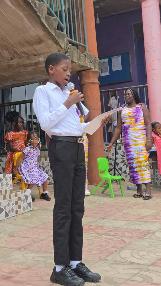 A pupil reciting on stage during a BBBIS programme
