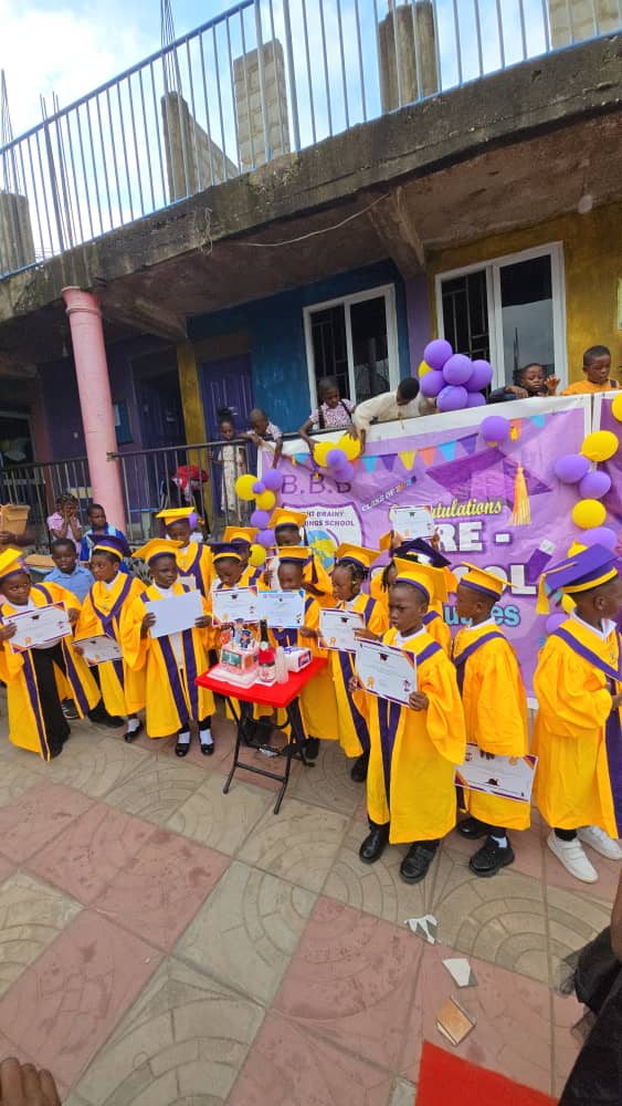 Pupils in graduation gowns gathered in the school courtyard